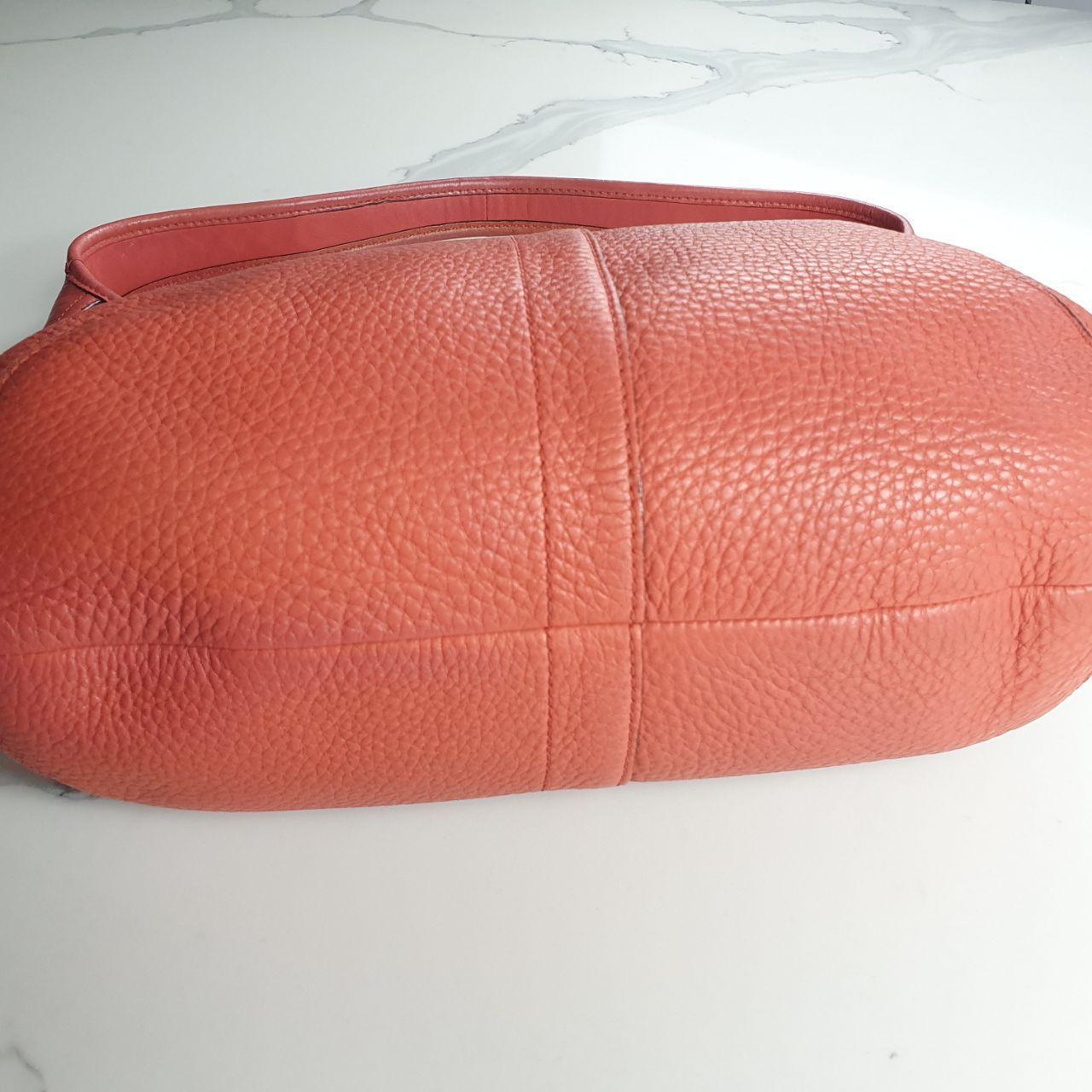 Authentic vintage Coach shoulder orange hobo bag.