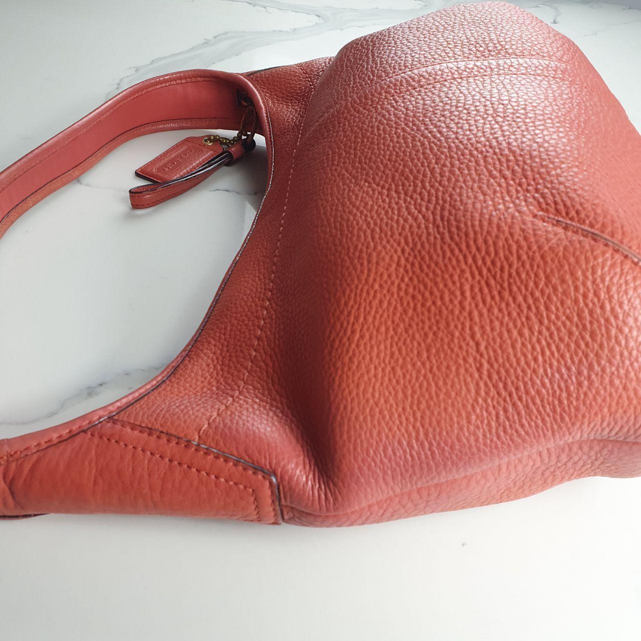 Authentic vintage Coach shoulder orange hobo bag.