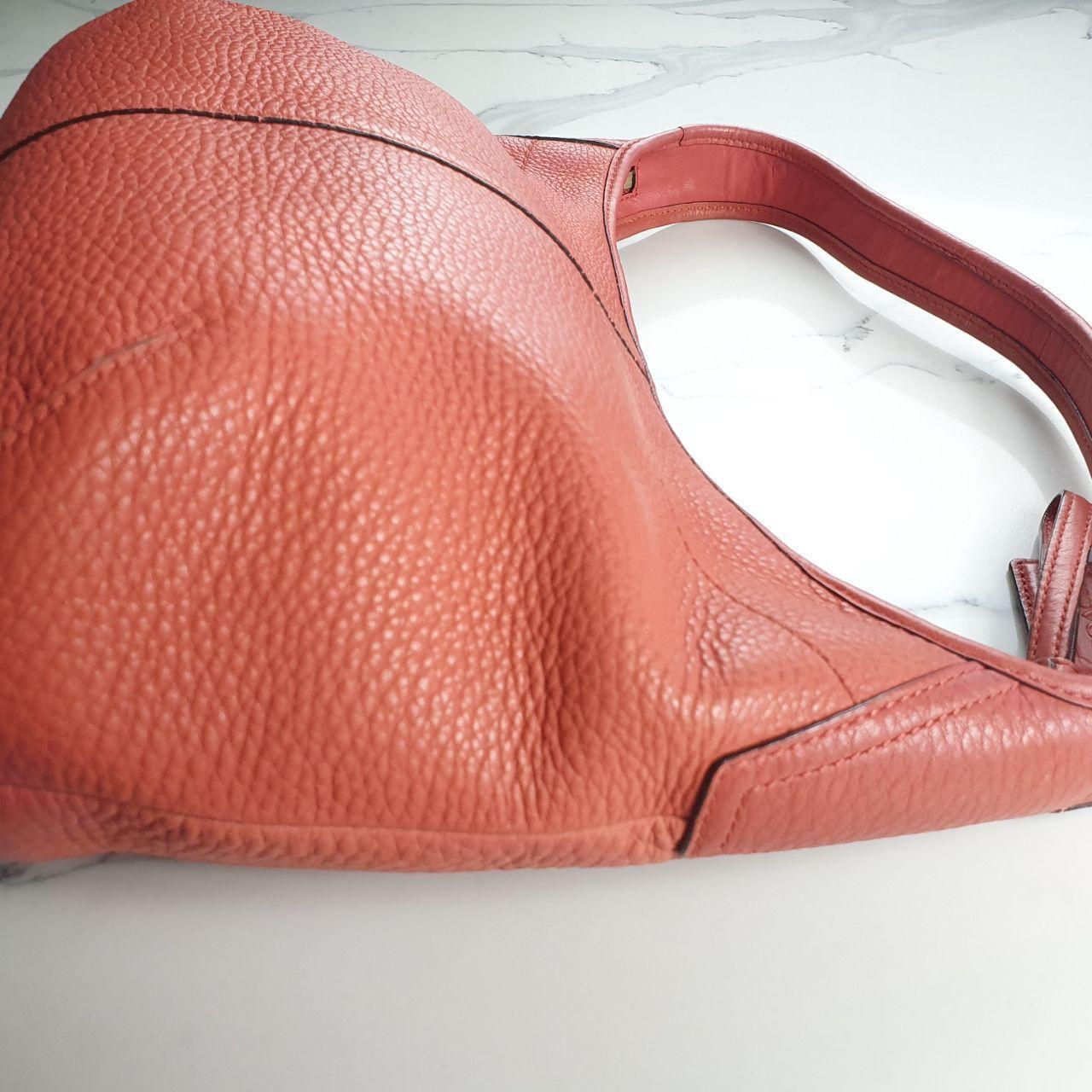 Authentic vintage Coach shoulder orange hobo bag.