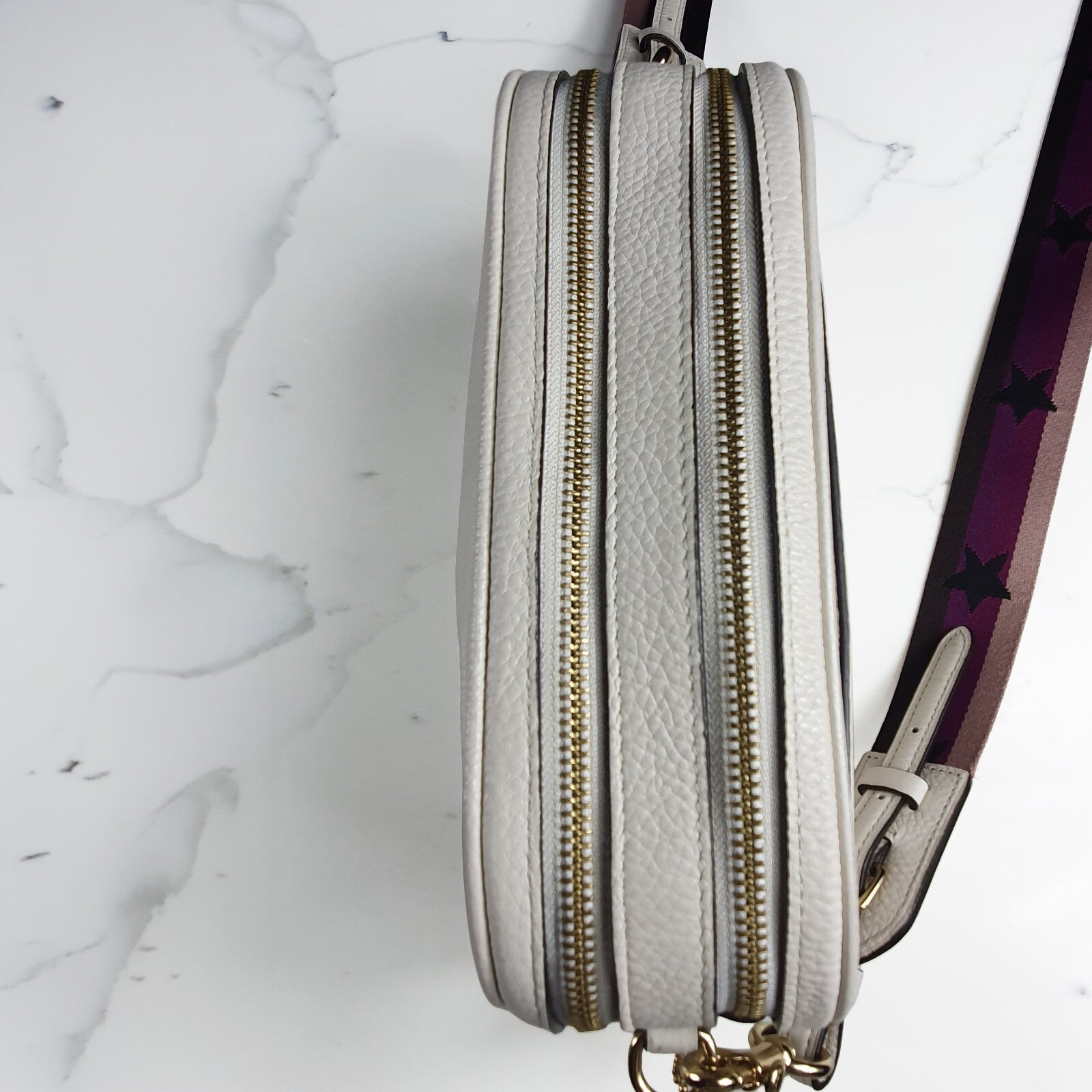 Authentic brand new Coach white leather crossbody bag with purple star strap