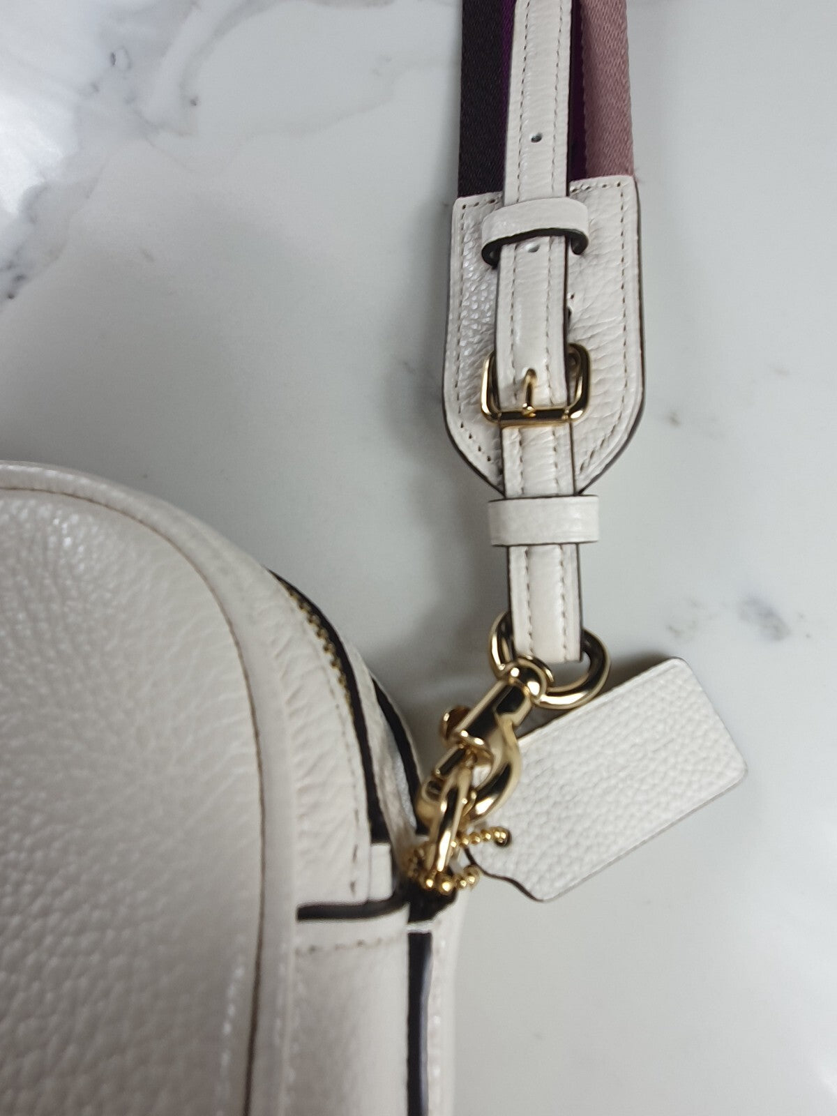 Authentic brand new Coach white leather crossbody bag with purple star strap